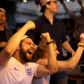 Football fans celebrate while watching the live broadcast of the final of the 2020 UEFA European Championships between England and Italy in the Oxford Arms pub in Camden on July 11, 2021 in London.