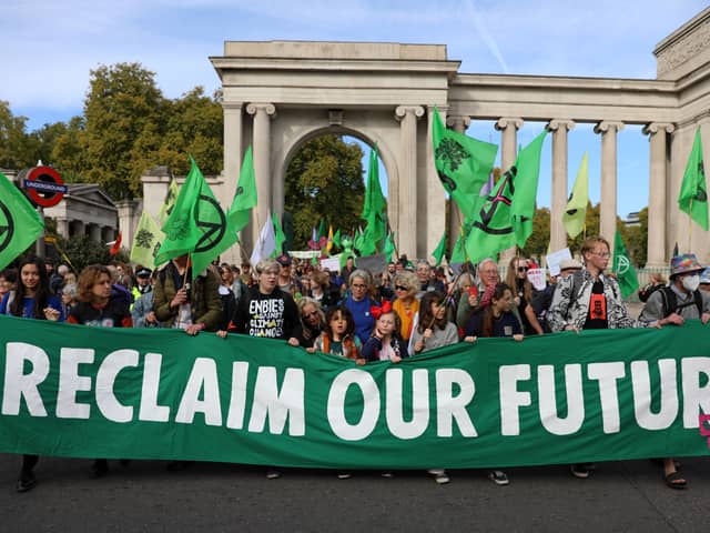 Protesters march into central London at a demonstration by the climate change protest group Extinction Rebellion, on October 16, 2022. Credit: Isabel Infantes/AFP.