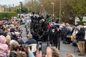 The funeral cortege for Paul O'Grady passes through the village of Aldington 