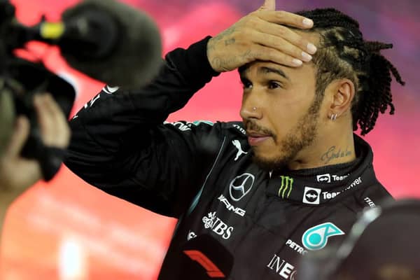 Second-placed Mercedes' British driver Lewis Hamilton reacts in the parc ferme of the Yas Marina Circuit after the Abu Dhabi Formula One Grand Prix on December 12, 2021 (Getty Images)