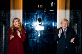 Boris Johnson (R) and his partner Carrie Symonds (L) outside 10 Downing street (Photo by Tolga Akmen / AFP) (Photo by TOLGA AKMEN/AFP via Getty Images)