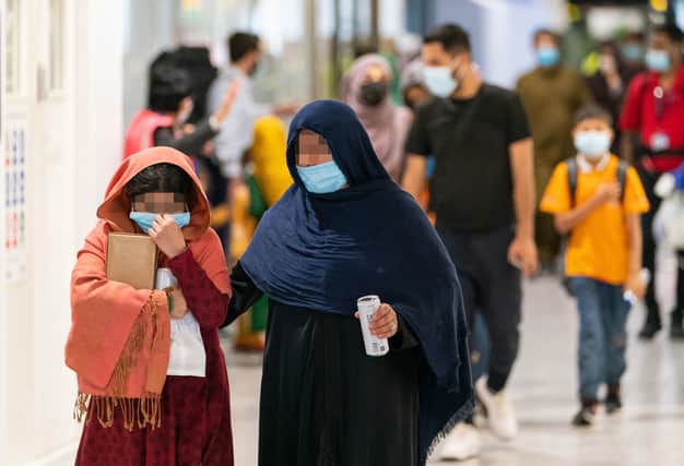 Refugees from Afghanistan arrive on a evacuation flight at Heathrow Airport on August 26, 2021 in London (image: WPA Pool/Getty Images)