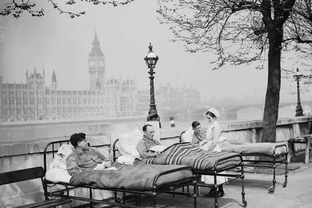 Tuberculosis patients from St. Thomas' Hospital rest in their beds in the open air by the River Thames in May, 1936.