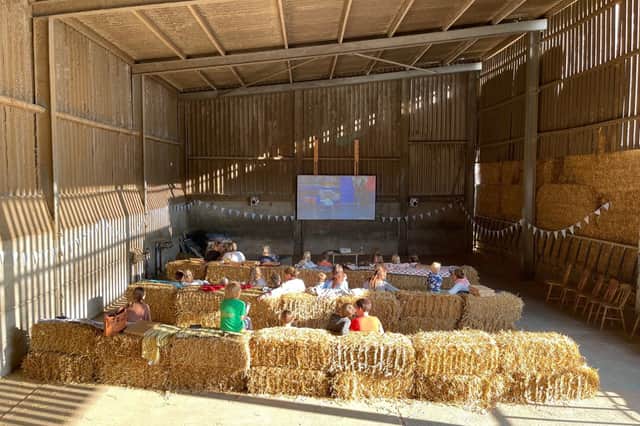 Brook Meadow's Moo-vie Nights transform the converted cowshed into a cosy cinema, where guests can settle in with a film after a day of lakeside adventures.