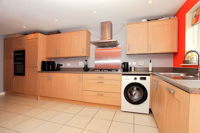 The modern kitchen has been designed as the heart of everyday life, offering room for busy mornings and relaxed family meals.