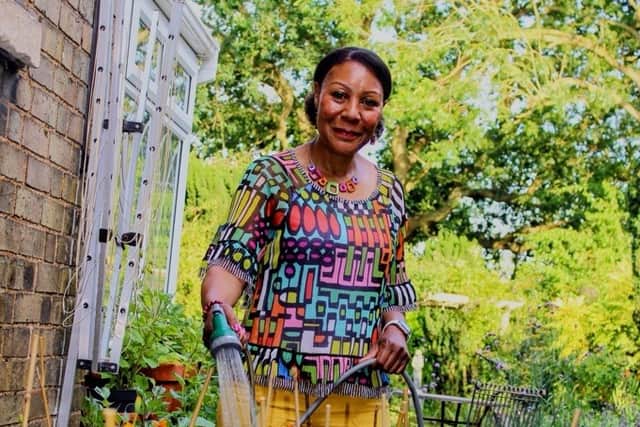 Andrea watering her garden