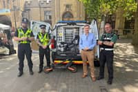 Andrew alongside local police performing a 'stop and seize' of E-scooters in the city centre