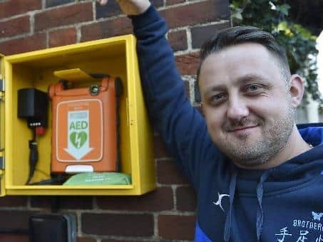 Aaron Parker, founding member outside with the new defibrillator.