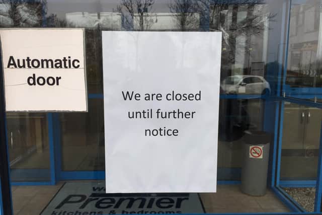 A notice placed in the window at Premier Kitchens