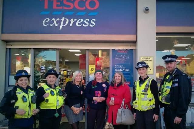 Police and community centre members give their thanks to Tesco. Photo: Cambridgeshire police