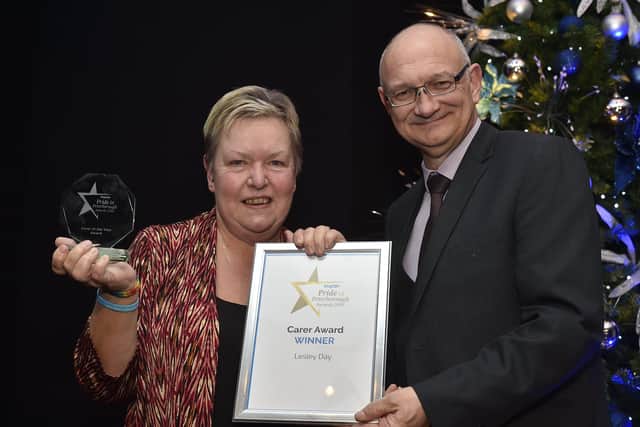 Peterborough Telegraph Pride in Peterborough Awards 2019.  Carer of the Year award winner Lesley Day with Mark Edwards. EMN-191012-003009009