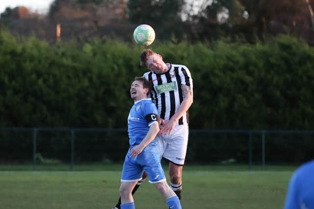 Liam Rodden in action for Peterborough Northern Star (stripes) against Desborough. Photo: James Cox.