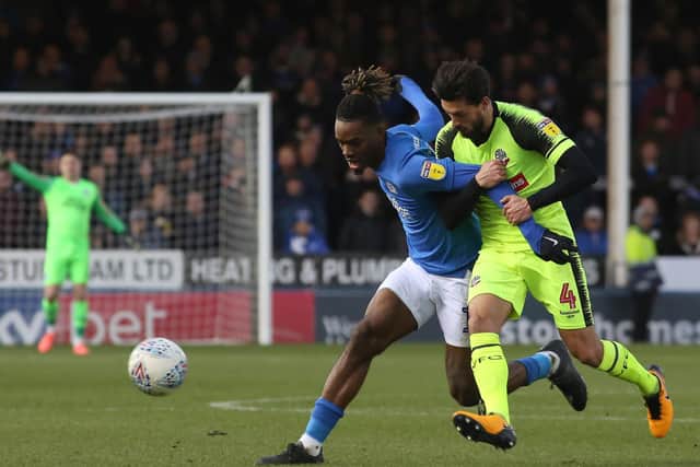 Ivan Toney of Peterborough United in action with Jason Lowe of Bolton Wanderers. Photo: Joe Dent/theposh.com.