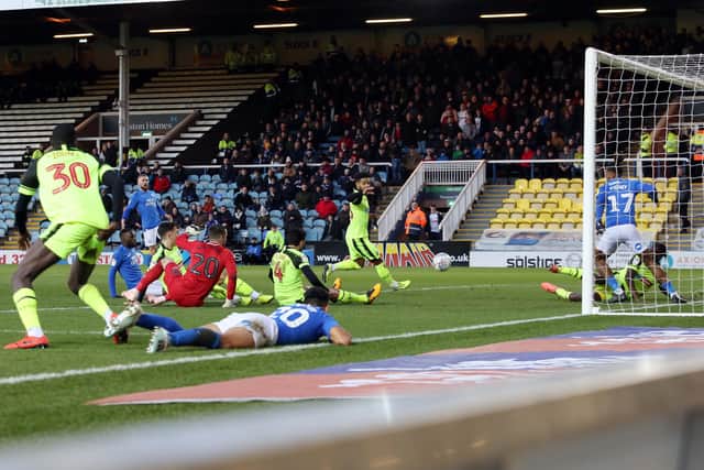 Posh striker Ivan Toney accidentally stops Mo Eisa's shot from going in against Bolton. Photo: Joe Dent/theposh.com.