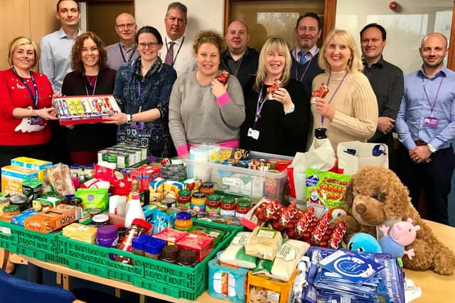 Fenland District Council staff pictured with the reverse advent calendar donation. From left: Michelle Bishop, Andy Brown, Lorraine Moore, Trevor Darnes, Amy Robinson, Andy Fox, Jo Evans, Justin Hanson, Michelle Page, Phil Westwood, Dawn Sadler, Lee Rider and Russell Watkins.