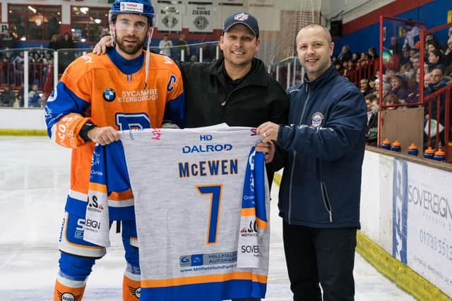 Peterborough ice hockey legend Dough McEwen is presented with a Phantoms shirt by captain James Ferrara and coach Slava Koulikov. Photo: Tom Scott.