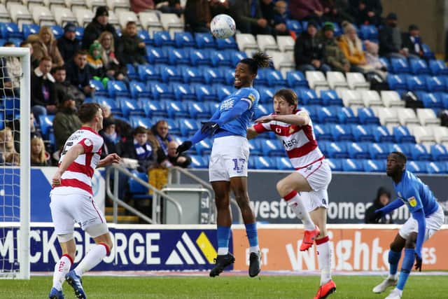 Ivan Toney and Tom Anderson in action during the Peterborough United v. Doncaster Rovers match. Photo: Joe Dent