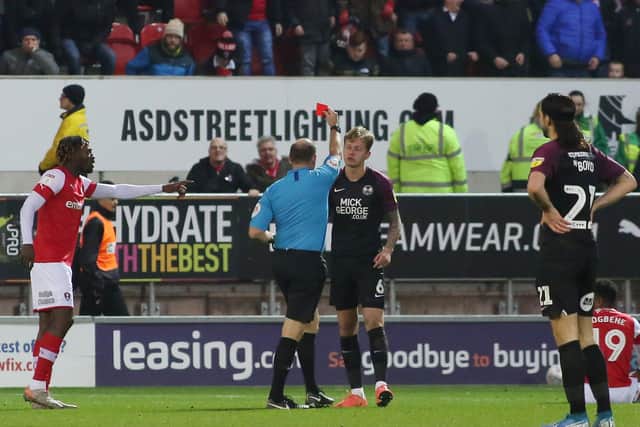 Frankie Kent of Peterborough United is sent off by the match referee Andy Haines. Photo: Joe Dent/theposh.com.