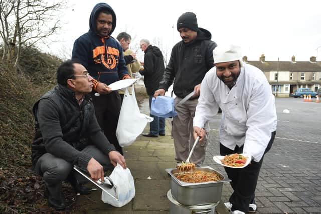 Chef Saiful Islam and volunteers from the Zi Foundation handing out food to the homeless at the car park behind the Brewery Tap EMN-150701-160156009