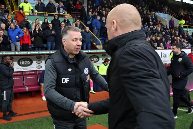 Peterborough United manager Darren Ferguson greets Burnley boss Sean Dyche before the match. Photo: Joe Dent/theposh.com.