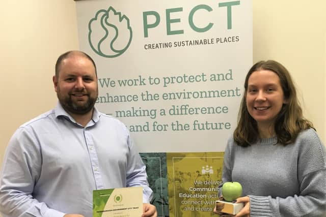 PECT's interim CEO Stuart Dawks and warm homes project officer Nikki Dekker with the Green Apple award