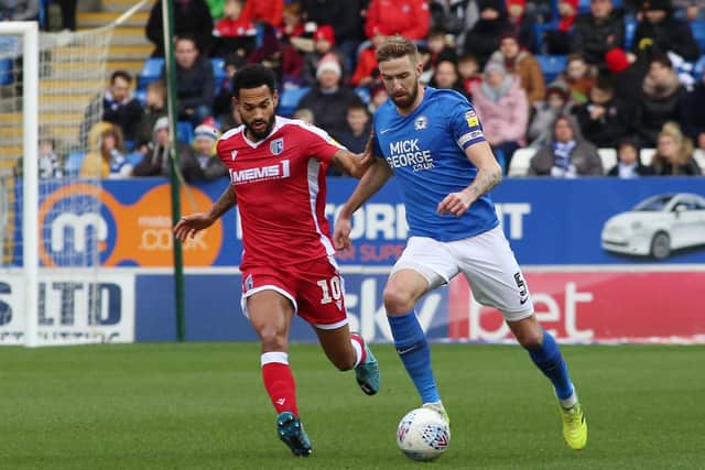 Mark Beevers of Peterborough United in action with Jordan Roberts of Gillingham. Photo: Joe Dent/theposh.com.