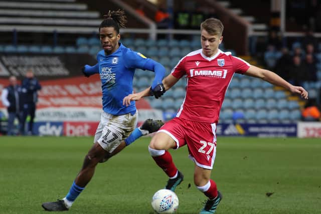 Ivan Toney of Peterborough United in action with Jack Tucker of Gillingham. Photo: Joe Dent/theposh.com.