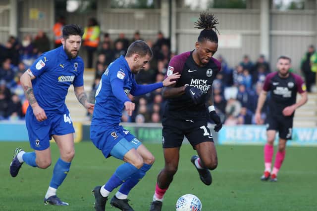Ivan Toney of Peterborough United in action with Shane McLoughlin and Anthony Wordsworth of AFC Wimbledon.  Photo: Joe Dent/theposh.com.