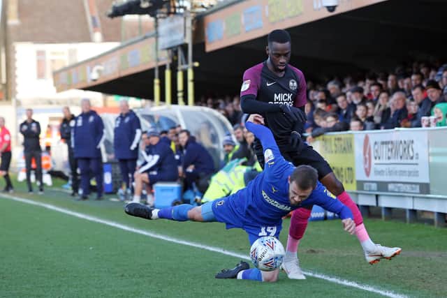Mohamed Eisa of Peterborough United in action with Shane McLoughlin of AFC Wimbledon. Photo: Joe Dent/theposh.com.