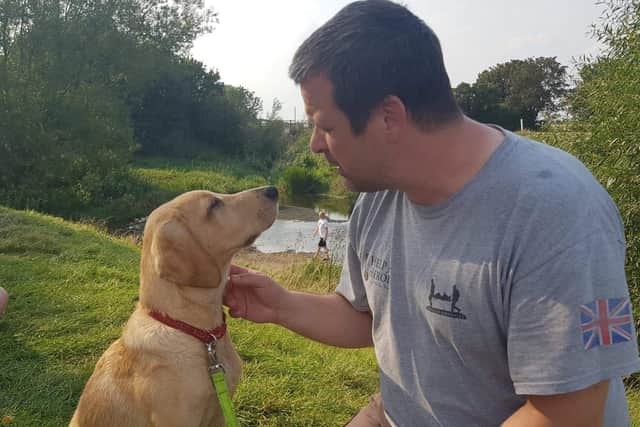 Blake Clark with PTSD assistance dog Odin