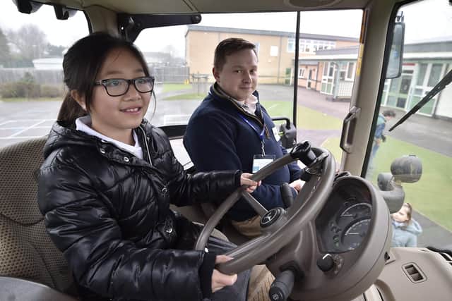 Kids country breakfast event at Welland Academy. Farmer Dan Bryant  and pupil Nancy Lin  in the tractor cab EMN-200122-145234009