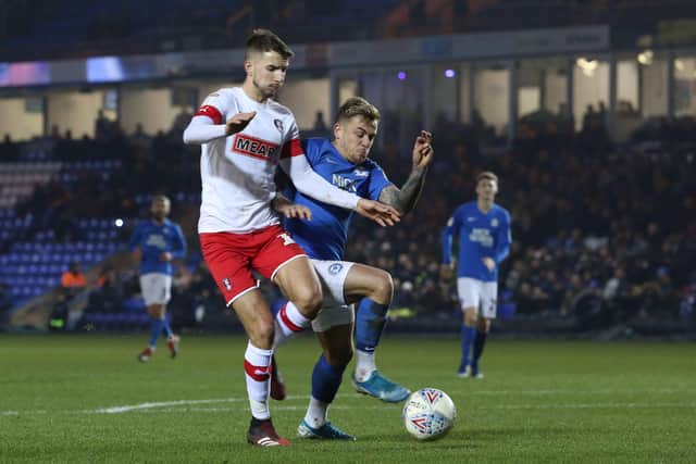 Sammie Szmodics of Peterborough United battles with Dan Barlaser of Rotherham United. Photo: Joe Dent/theposh.com.