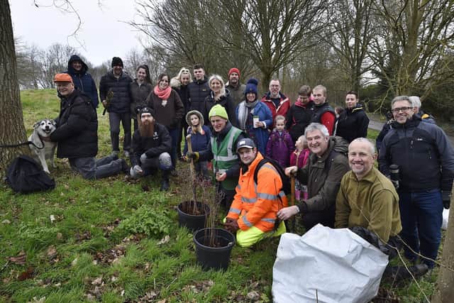 Tony Cook from PECT (front right) and Cllr Nick Sandford (front left) with local volunteers planting trees at Bretton Park. EMN-200126-145543009