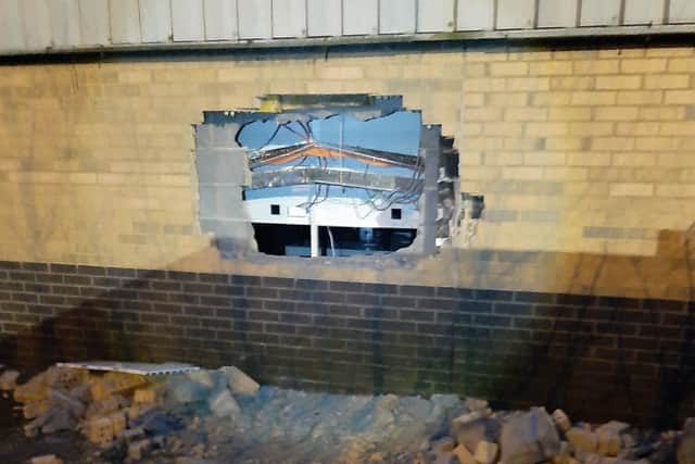 The burglars smashed a hole in the wall