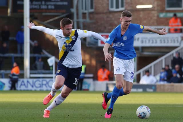 Jack Taylor of Peterborough United in action with James Henry of Oxford United. Photo: Joe Dent/theposh.com.