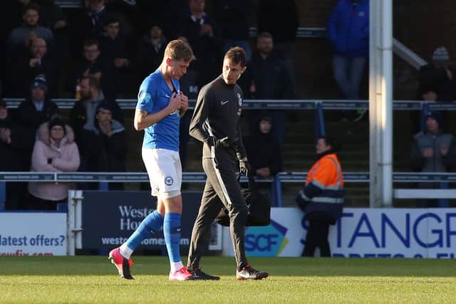 Posh defender Frankie Kent limps off injured early in the game against Oxford. Caption: Joe Dent/theposh.com.