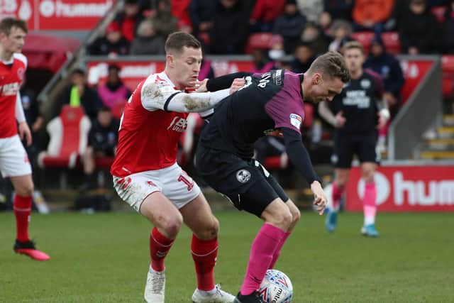 Jack Taylor of Peterborough United in action with Paul Coutts of Fleetwood Town. Photo: Joe Dent/theposh.com.