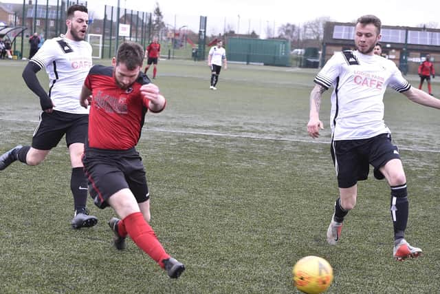 Ritchie Baines of Netherton (red) shoots during a 3-1 win over Long Sutton at the Grange. Photo: David Lowndes.