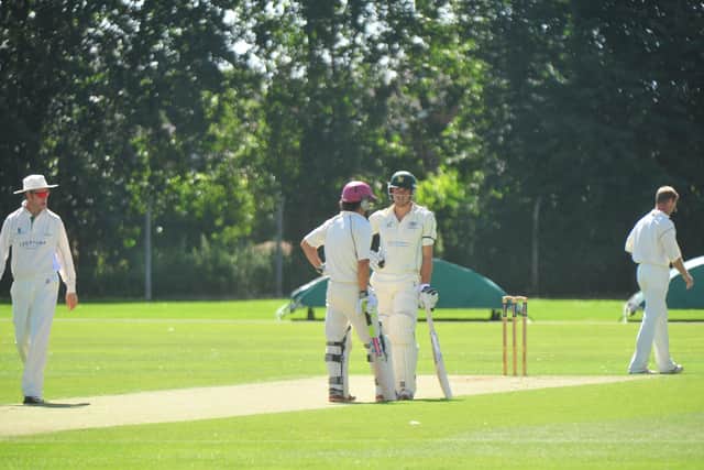 Marcus Stoinis (right) and David Clarke having a chat while batting together for Peterborough Town in 2012.
