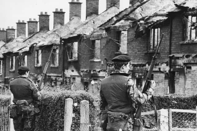 12th August 1971:  British soldiers stand on guard over houses that have been wrecked by bombs, fired by the IRA in the central area of Belfast.  (Photo by Hulton Archive/Getty Images) PPP-190814-123658001