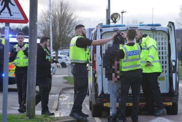 Police making an arrest outside Southfields Community Centre