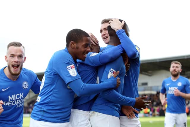 Mo Eisa of Peterborough United celebrates scoring his goal with team-mates. Photo: Joe Dent/theposh.com/