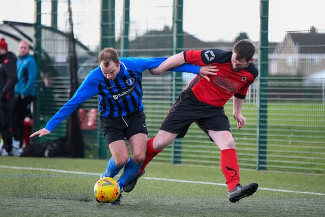 Ritchie Baines of Netherton (red) takes on a Moulton Harrox player. Photo: James Richardson.