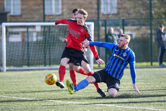 Tom Randall (red) in action for Netherton against Moulton Harrox. Photo: James Richardson.