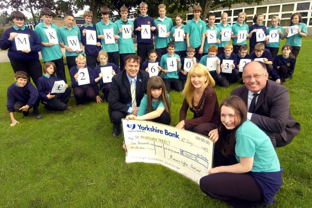 Pupils from Raincliffe School present a cheque to Suzanne Mehmet for the Mkwakwani School project.