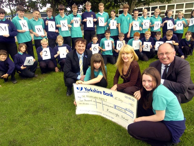 Pupils from Raincliffe School present a cheque to Suzanne Mehmet for the Mkwakwani School project.