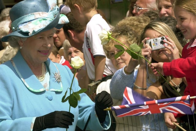 HM The Queen is handed some white roses - the Yorkshire emblem -  by some local schoolchildren on her visit to Ripon in 2004.