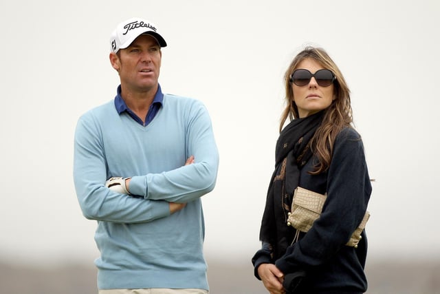 Shane Warne with Elizabeth Hurley during the third round of The Alfred Dunhill Links Championship at the Kingsbarns Golf Links on October 1, 2011 in Kingsbarns, Scotland. (Photo by Andrew Redington/Getty Images)