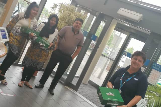 The sisters presenting cakes to staff at Peterborough City Hospital.