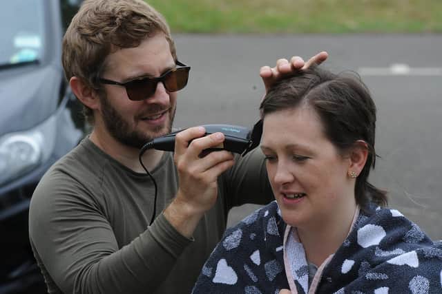 Steve Church cutting the hair with Jessica Cox